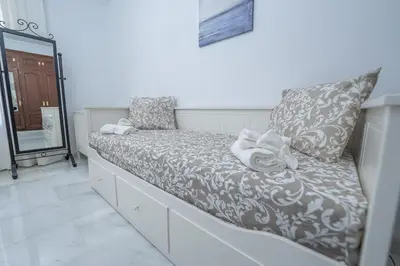 a couch with towels on it in a room at VILLA CAPITAN in Sanlúcar de Barrameda
