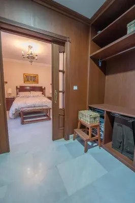 a master bedroom with a bed and a fireplace at VILLA CAPITAN in Sanlúcar de Barrameda