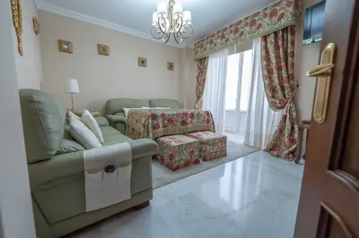a living room with a couch and a chair at VILLA CAPITAN in Sanlúcar de Barrameda