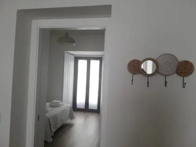 a room with a bed and two mirrors on the wall at CASA PALACIO CABALLEROS 7 con Parking in Sanlúcar de Barrameda