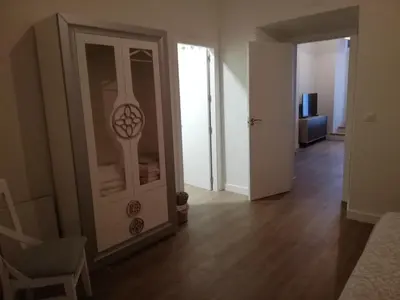 a living room with a glass door and a chair at CASA PALACIO CABALLEROS 7 con Parking in Sanlúcar de Barrameda