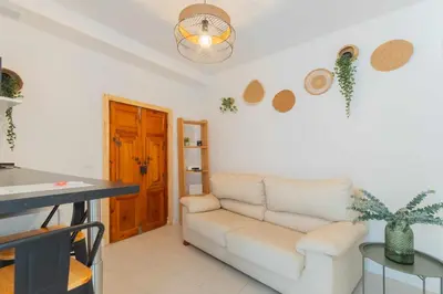 a living room with a couch and a table at Jacuzzi Amanecer de Plata Decoración Romántica in Chiclana de la Frontera