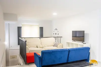 a living room with a couch and a tv at Loft Santa María by Cadiz Time in Cádiz