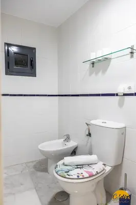 a white bathroom with a toilet and a sink at Loft Santa María by Cadiz Time in Cádiz