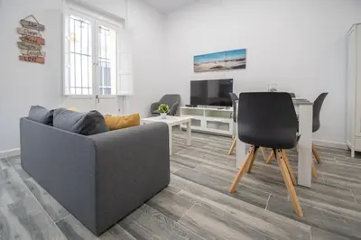 a living room with a couch and a table at Estudio Al Sur de Cádiz in Cádiz