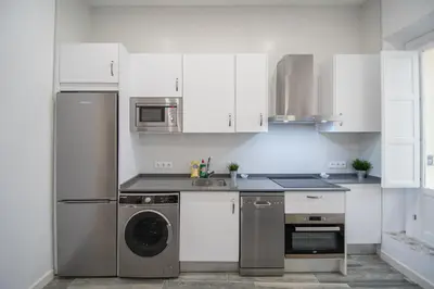 a kitchen with a stainless steel refrigerator and a dishwasher at Estudio Al Sur de Cádiz in Cádiz
