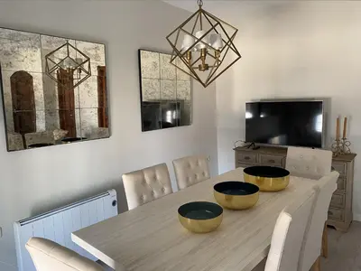 a dining room table with bowls on top of it at Ático San Juan in Sanlúcar de Barrameda