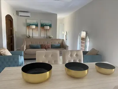 a living room with a table with two bowls on it at Ático San Juan in Sanlúcar de Barrameda