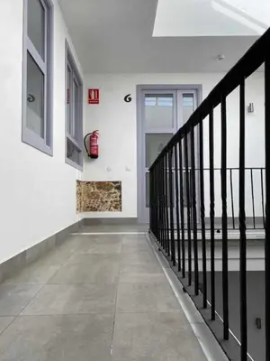 a hallway of a house with a staircase and a fireplace at Apartamentos Casa Macías in Cádiz