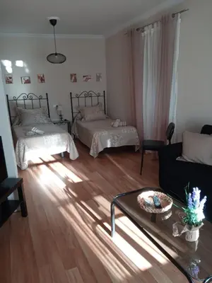a living room with two beds and a coffee table at La Casa de Pepa in Jerez de la Frontera