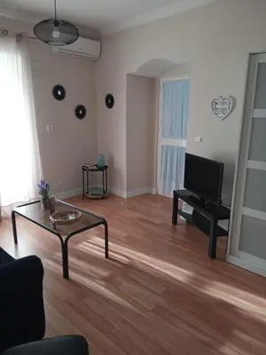 a living room with a coffee table and a television at La Casa de Pepa in Jerez de la Frontera