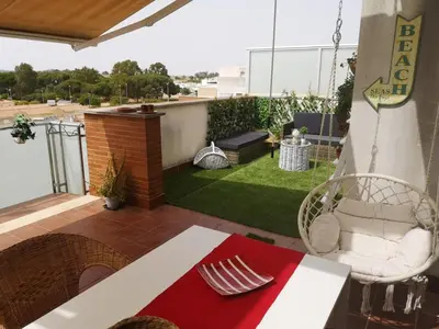 a patio with a table and chairs on a balcony at Ático Love in Jerez de la Frontera