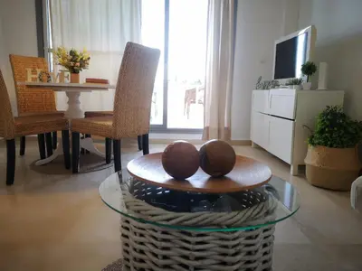 a living room with a glass table and chairs at Ático Love in Jerez de la Frontera