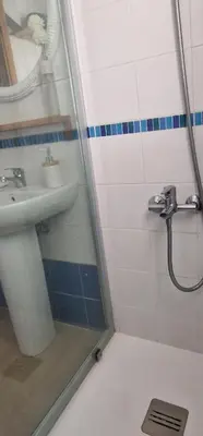 a bathroom with a shower and a sink and a mirror at Ático Love in Jerez de la Frontera