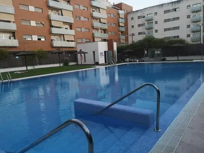 a large swimming pool in front of a building at Ático Love in Jerez de la Frontera