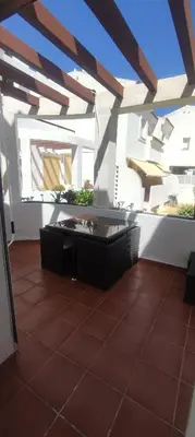 a balcony with a table and a view of a building at Costa Ballena!!! House on Mediterranean Coast with pool and golf!!! Dúplex!!! in Costa Ballena