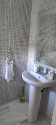 a bathroom with a sink and a mirror at Costa Ballena!!! House on Mediterranean Coast with pool and golf!!! Dúplex!!! in Costa Ballena