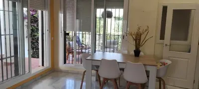a dining room with a table and white chairs at Costa Ballena!!! House on Mediterranean Coast with pool and golf!!! Dúplex!!! in Costa Ballena