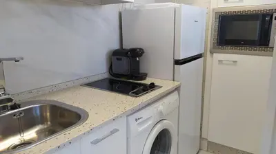 a small kitchen with a sink and a refrigerator at Sherryflat Luna in Jerez de la Frontera