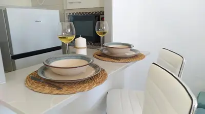a table with two bowls and wine glasses on it at Sherryflat Luna in Jerez de la Frontera