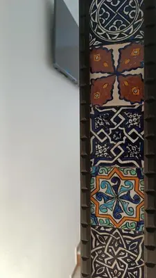 a tie with a pattern on it next to a wall at Sherryflat Luna in Jerez de la Frontera