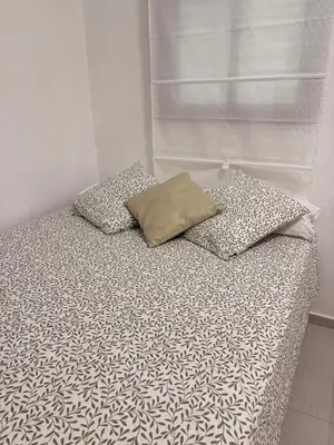 a bed with two pillows on top of it at Estudio Soniquete in Jerez de la Frontera