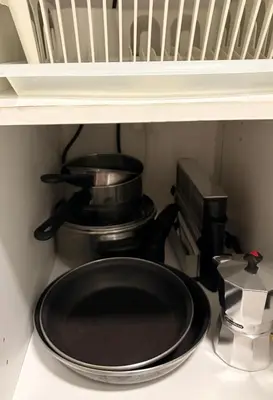 a stove with a pot and a pan on a shelf at Estudio Soniquete in Jerez de la Frontera