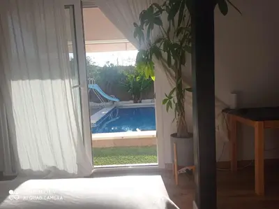 a bedroom with a window with a view of a swimming pool at VILLA SANTA CLARA in Chiclana de la Frontera