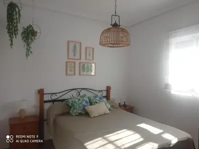 a bedroom with a bed and a pendant light at VILLA SANTA CLARA in Chiclana de la Frontera