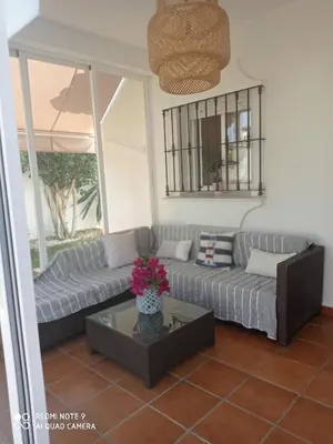a living room with a couch and a table at VILLA SANTA CLARA in Chiclana de la Frontera