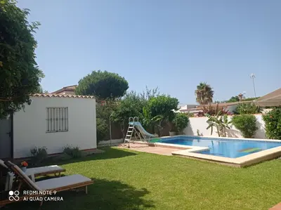 a backyard with a slide and a swimming pool at VILLA SANTA CLARA in Chiclana de la Frontera