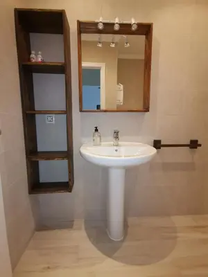 a bathroom with a sink and a mirror at Apartamento Wifi, Garaje Centro y playa in Chipiona