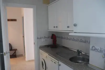 a kitchen with a sink and a counter top at Apartamento Wifi, Garaje Centro y playa in Chipiona
