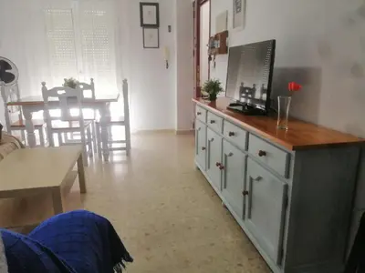 a living room with a tv on top of a dresser at Apartamento Wifi, Garaje Centro y playa in Chipiona