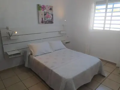 a bed in a white room with a window at Casa Enrique in Cádiz