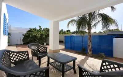 a group of chairs and tables on a patio at Casa Enrique in Cádiz