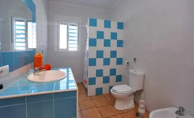 a bathroom with a toilet and a sink at Casa Juani in Conil de la Frontera