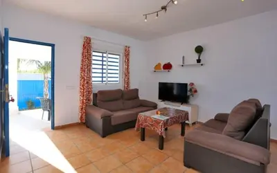 a living room with two couches and a television at Casa Juani in Conil de la Frontera