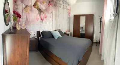 a bedroom with a bed and a dresser in a room at Hope's ático-apartamento in Cádiz