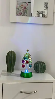 a small christmas tree on top of a dresser at Hope's ático-apartamento in Cádiz
