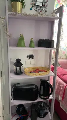 a white shelf with pots and pans on it at Hope's ático-apartamento in Cádiz