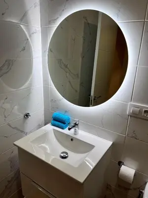 a bathroom with a white sink and a mirror at GATU PREMIUM Villa La Pepa in Cádiz