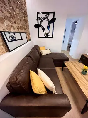 a living room with a brown leather couch and yellow pillows at GATU PREMIUM Villa La Pepa in Cádiz