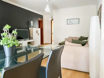 a living room with a glass table and a couch at Apartamento Sol y Sal in Chiclana de la Frontera