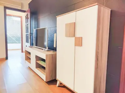 a room with a white cabinet and a television at Apartamento Sol y Sal in Chiclana de la Frontera