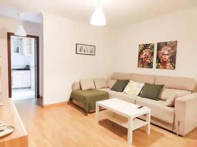 a living room with a couch and a table at Apartamento Sol y Sal in Chiclana de la Frontera
