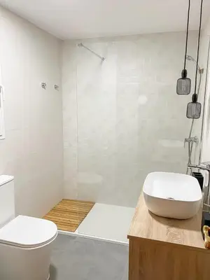 a bathroom with a toilet and a glass shower at Apartamento Sol y Sal in Chiclana de la Frontera