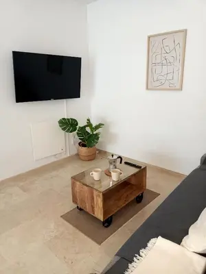 a living room with a coffee table and a flat screen tv at Azvalia - Larga 112 in El Puerto de Santa María