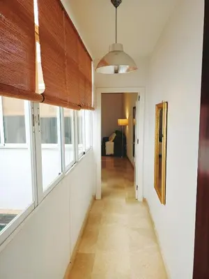 a hallway of a house with windows at Azvalia - Larga 112 in El Puerto de Santa María