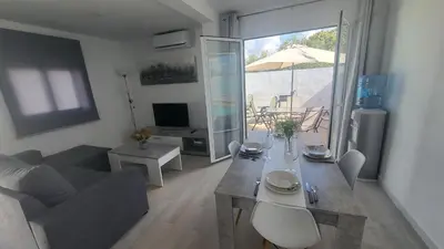 a living room with a couch and a table with chairs at Villa Romadian in Chiclana de la Frontera